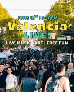 A crowded street festival with people walking among vendor tents, beneath text promoting "Valencia Live!" with details about live music, art, and free fun on June 12th, 5–10 PM.