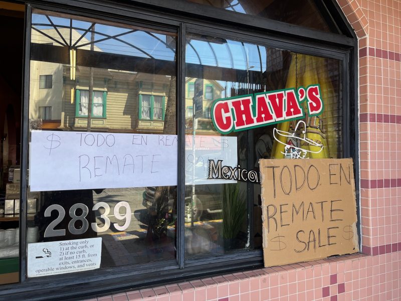Storefront window with signs reading "TODO EN REMATE" and "SALE $" in Spanish and English. The address "2839" is visible, along with a "Chava's" sign and a no smoking notice.
