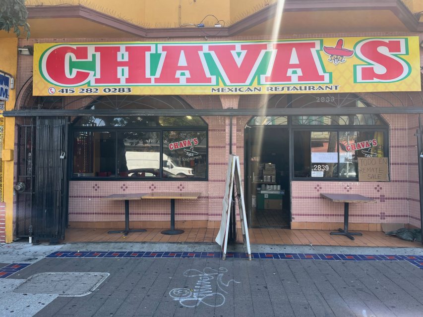 Street view of Chava's Mexican Restaurant with large yellow and green sign, open entrance, menu board outside, and tiled pink exterior.