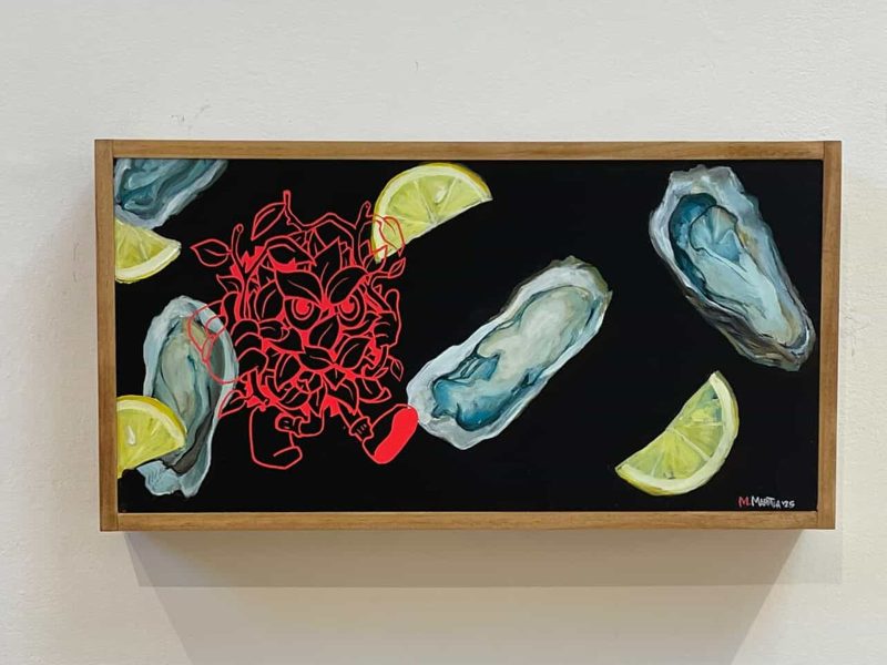A framed artwork depicts oysters and lemon wedges on a black background, with an abstract red line drawing overlapping one oyster.