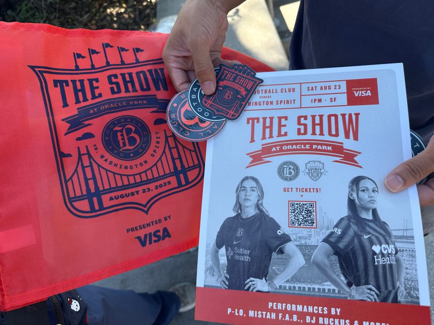 Bay FC women's soccer team makes its play for San Francisco 2 A person holds a red flag, stickers, and a flyer promoting "The Show" soccer event at Oracle Park on August 23, 2025, featuring Bay FC vs. Washington Spirit.