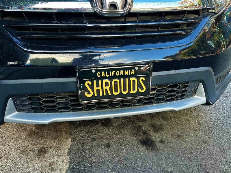 A black Honda car with a California license plate that reads "SHROUDS" in yellow letters.