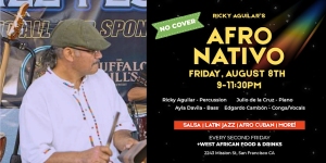A man plays percussion on stage next to a flyer for an Afro Nativo music event scheduled for Friday, August 8th, featuring salsa, Latin jazz, and Afro Cuban genres.