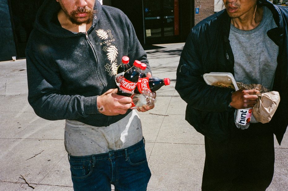 A man holding bottles of soda.