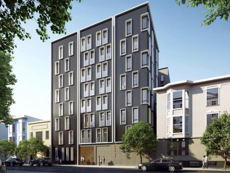 Modern mid-rise apartment building with a dark gray facade and large windows, situated on a sunny street with parked cars and nearby trees.