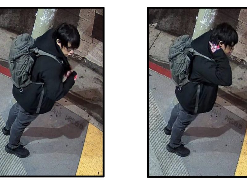 Two surveillance images show a person with dark hair, glasses, a gray backpack, and a black jacket standing on a sidewalk near a red curb at night.