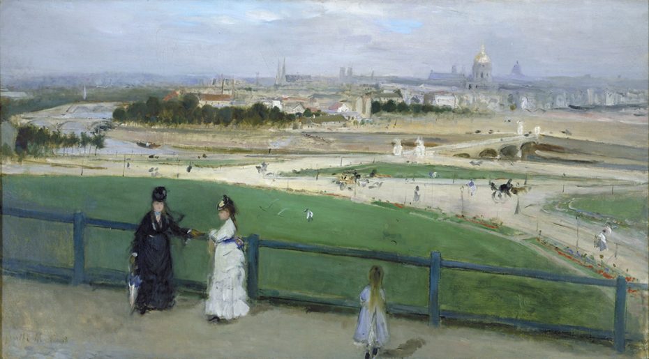 Two women and a girl stand by a fence overlooking a wide park with people, trees, and distant buildings under a cloudy sky.