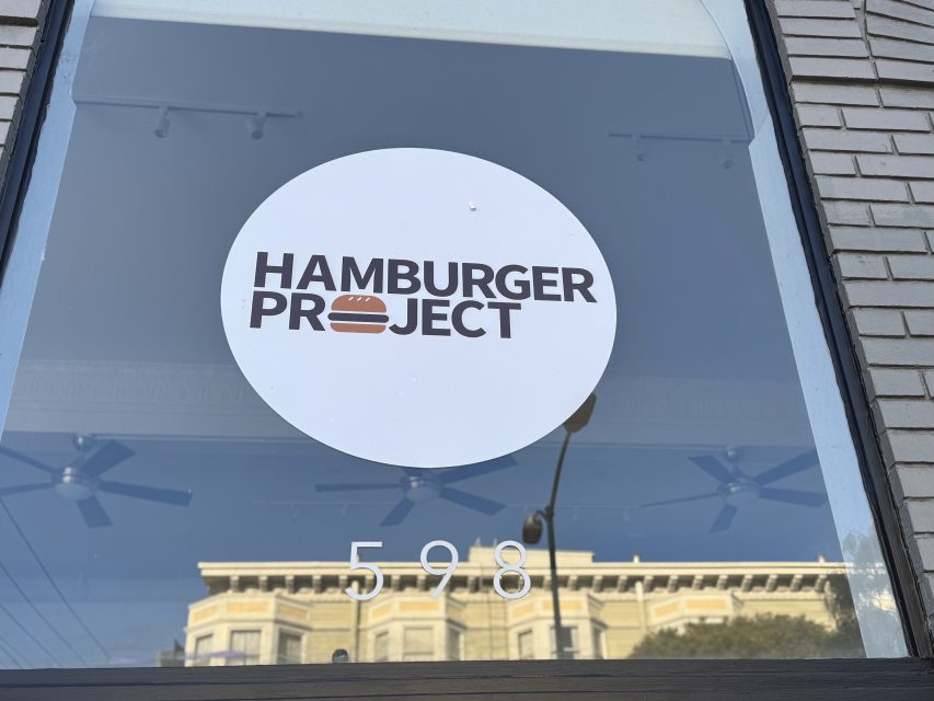 A round sign on a window reads "Hamburger Project" with a burger icon; the number 598 is displayed below the sign.
