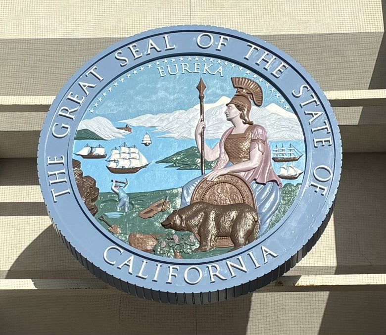 The Great Seal of the State of California featuring Minerva, a grizzly bear, a sheaf of grain, ships, and mountains, with "Eureka" at the top.