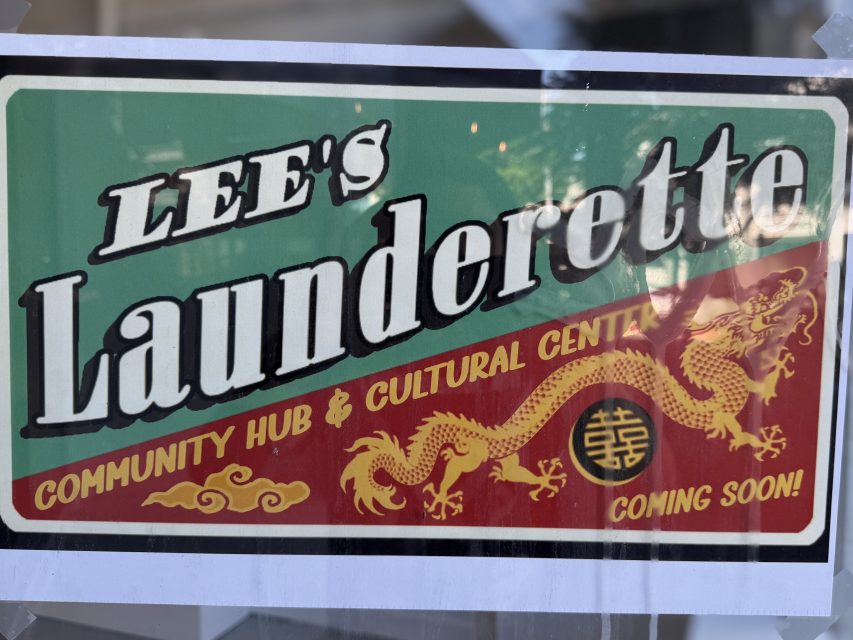 A sign reads "LEE'S Launderette Community Hub & Cultural Centre" with a dragon graphic and the words "Coming Soon!" in the bottom corner.