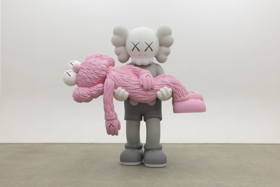 A gray cartoon-like figure with crossed-out eyes holds a pink, furry figure with similar features in its arms, standing on a plain concrete floor against a white wall.