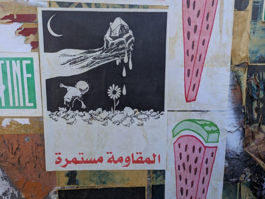 A black and white illustration shows a hand dripping liquid over a house, a child crawling among rocks toward a daisy, with Arabic text below and watermelon art on the side.