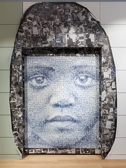 Large grayscale artwork featuring a close-up of a woman's face composed of small images and text, framed by a collage border with various black-and-white photographs and clippings.