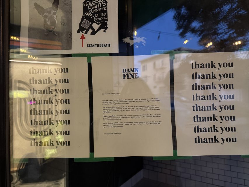 Multiple signs on a window, including repetitive "thank you" messages and a central notice from Damn Fine, along with a Housing Rights Committee flyer above.