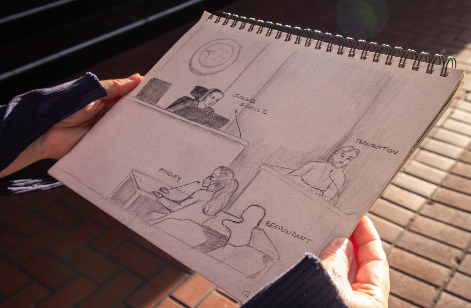 A person holds a sketchpad showing a courtroom scene drawing with labeled figures: judge, attorney, respondent, and translator.