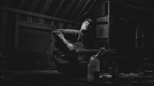 A man playing a guitar.