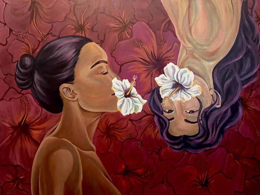 Two women face each other, one upright and one upside down, with white hibiscus flowers covering their mouths against a red hibiscus floral background.
