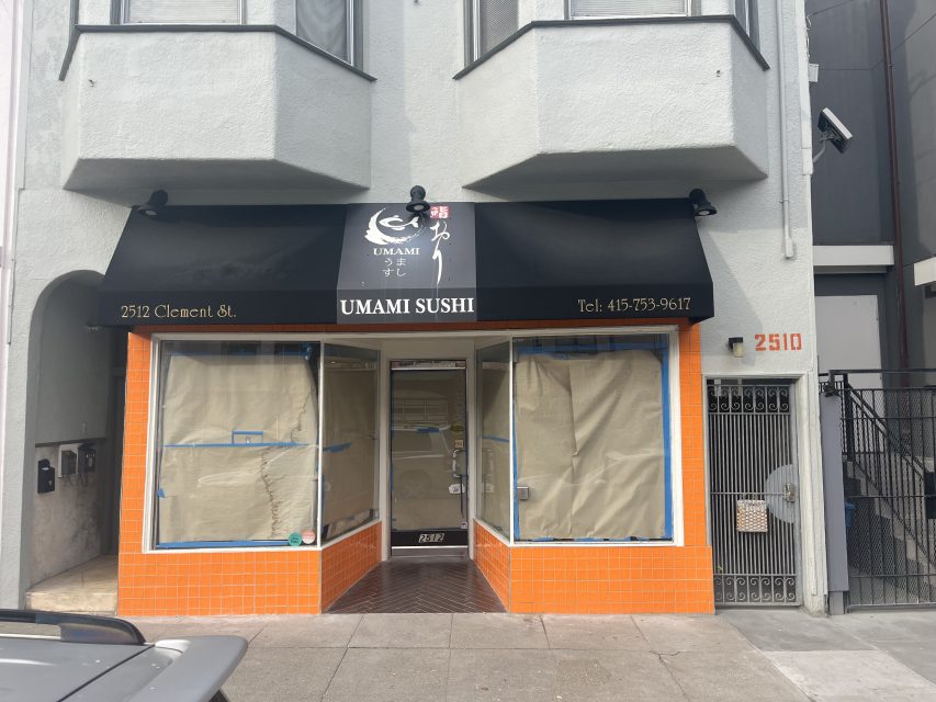 Storefront of Umami Sushi at 2512 Clement St., with windows covered in paper and an orange tile exterior, indicating the restaurant is closed or under renovation.