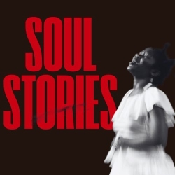 A woman in a white dress sings passionately in front of large red text that reads "SOUL STORIES" on a black background.