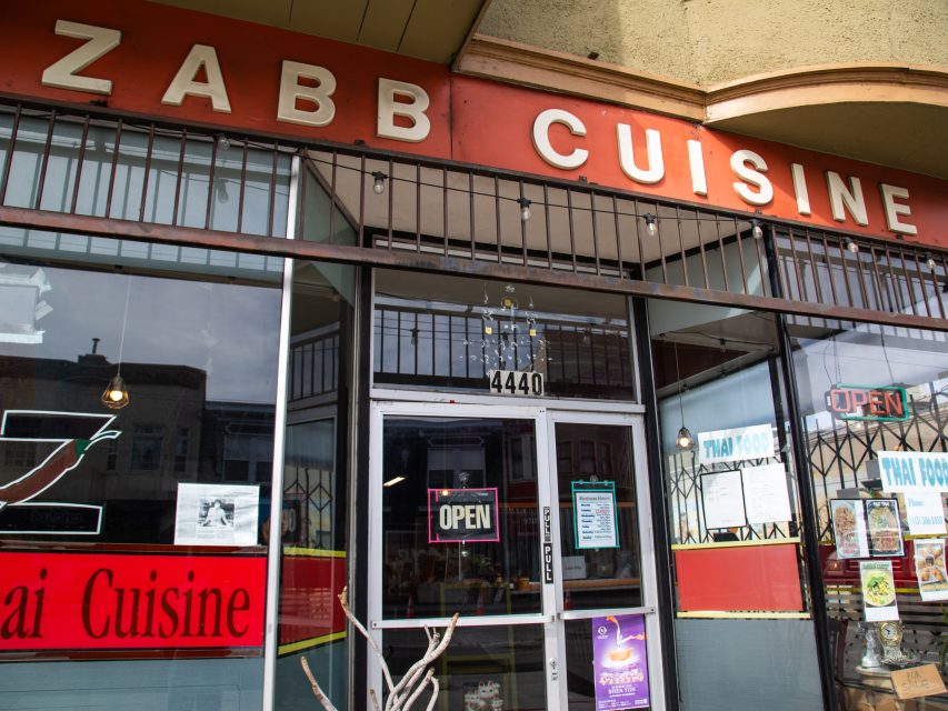Storefront of Zabb Cuisine restaurant with a red sign, glass windows, and an "OPEN" sign displayed on the door at 4440.