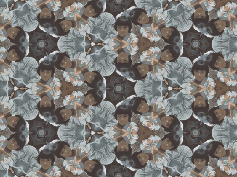 A kaleidoscopic pattern featuring repeated images of a young child with short dark hair, wearing a striped outfit, creating a symmetrical, geometric design.