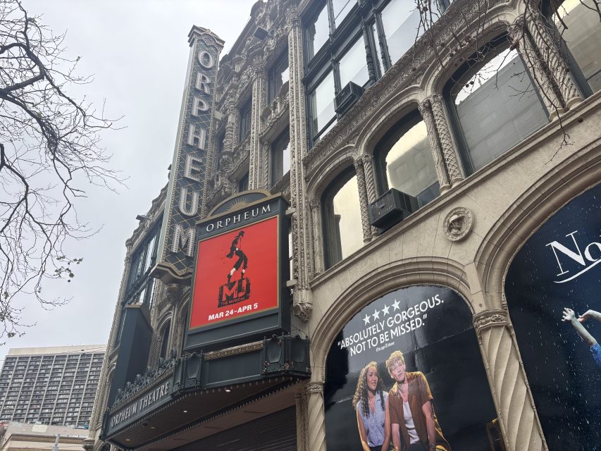 The Orpheum Theatre exterior with a digital marquee advertising the “MJ” musical, running from March 24 to April 5. Posters for other shows are also visible.