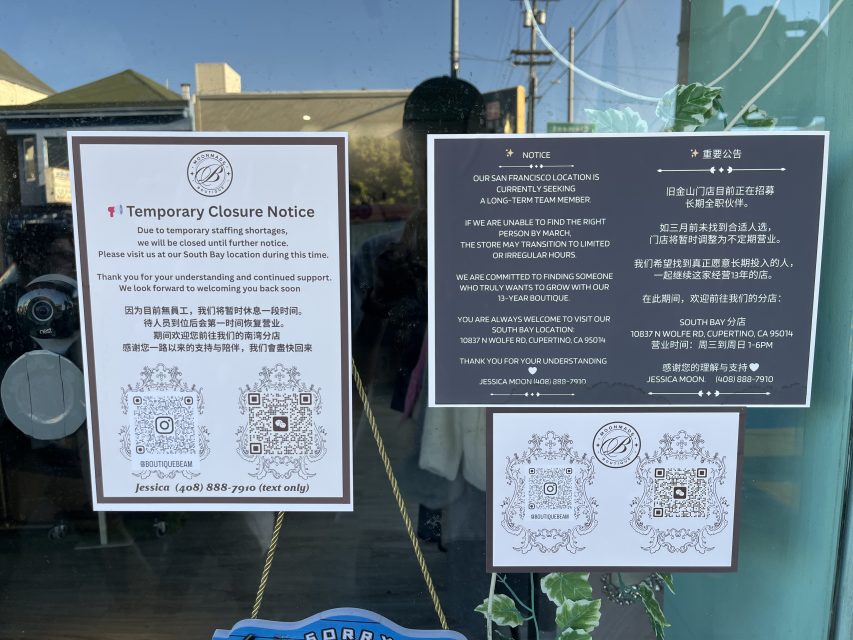 Three notices on a glass door announce the temporary closure of a business location due to staffing shortages, with contact information and instructions for customers.