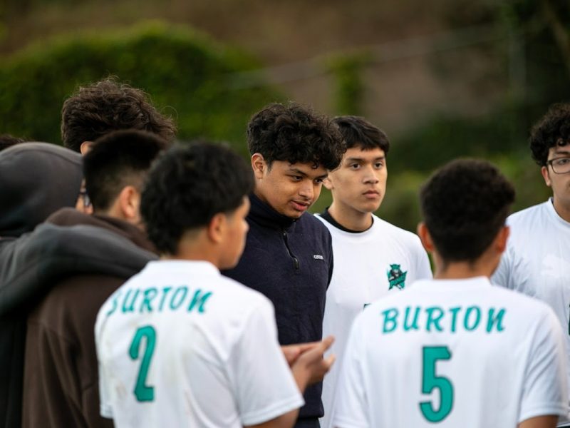 He’s a high school senior. And Burton High’s soccer coach. 