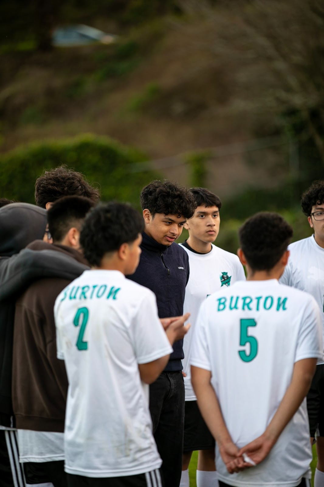 He's a high school senior. And Burton High's soccer coach.