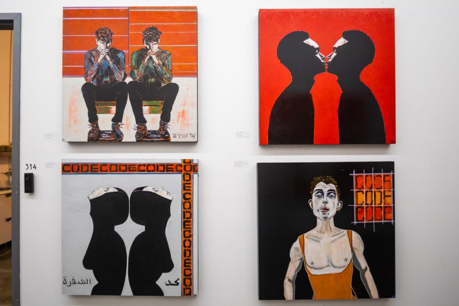 Four contemporary paintings hang on a white wall; subjects include mirrored figures, silhouettes, and abstract elements, predominantly using red, black, and orange tones.