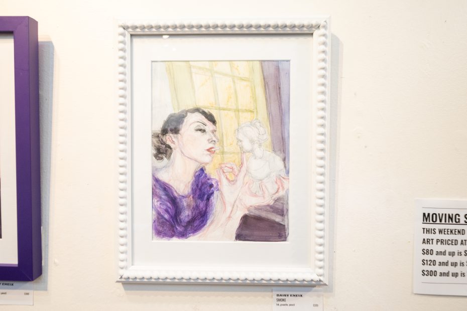 A framed painting depicts a woman in a purple top holding a small statue, looking thoughtfully out a yellow window.