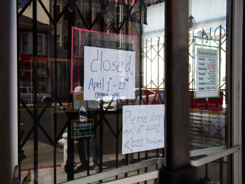 A storefront window displays handwritten signs stating the business is closed from April 1โ22 and instructing to drop mail at unit #442.